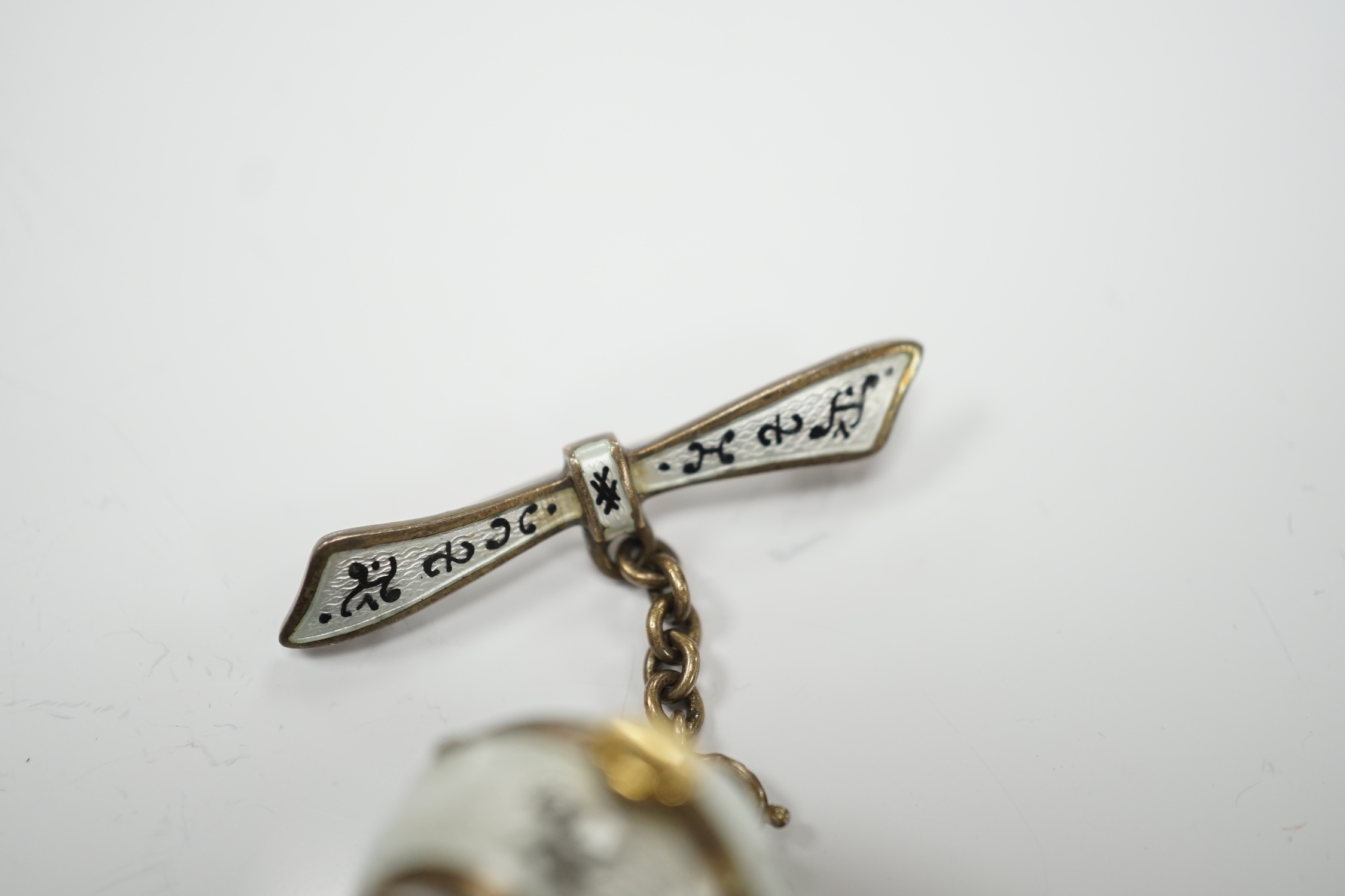 An early to mid 20th century silver and two colour enamel globe pendant watch, on suspension chain with brooch attachment, diameter 20mm.